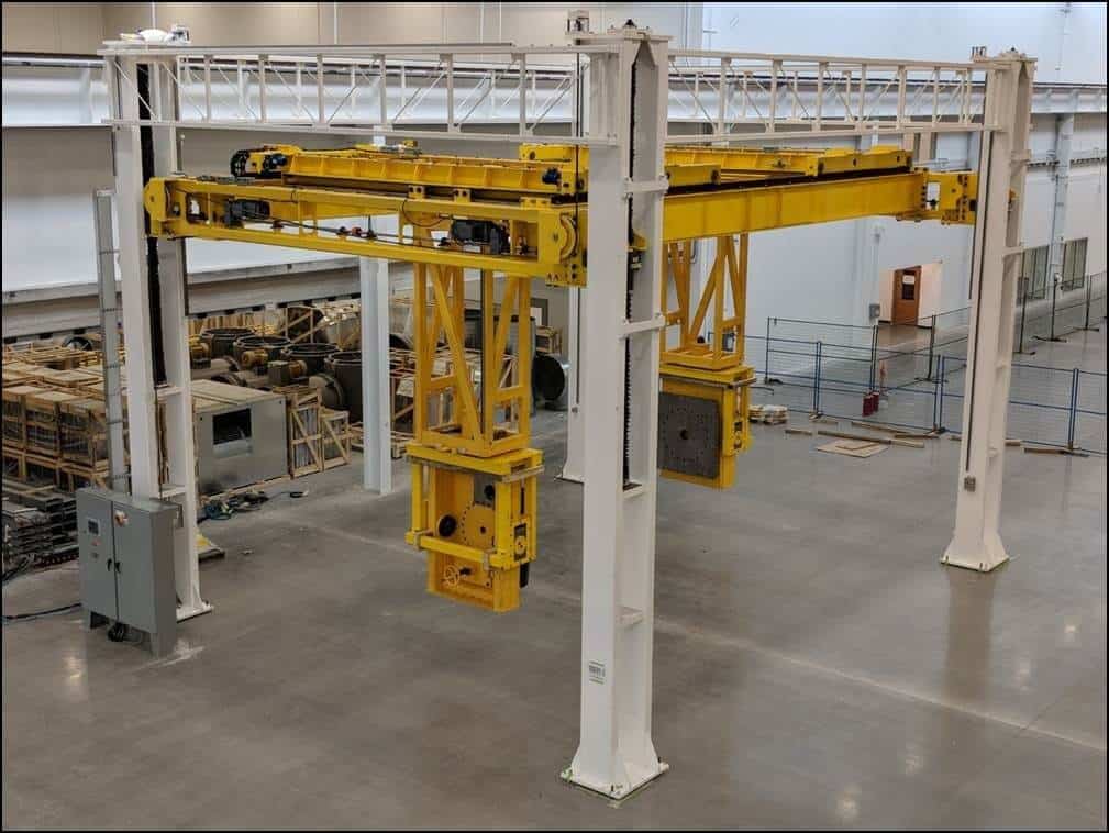 Yellow custom work positioners within an industrial facility with a four-post lift system.