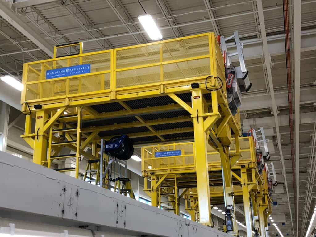 Set of industrial yellow gantry systems within a maintenance facility.