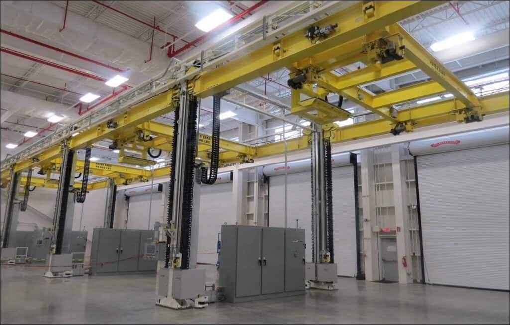 Yellow 4-post lifting system in clean, modern facility.