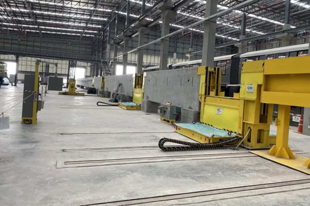 Maintenance facility for monorails with yellow lifting platforms.